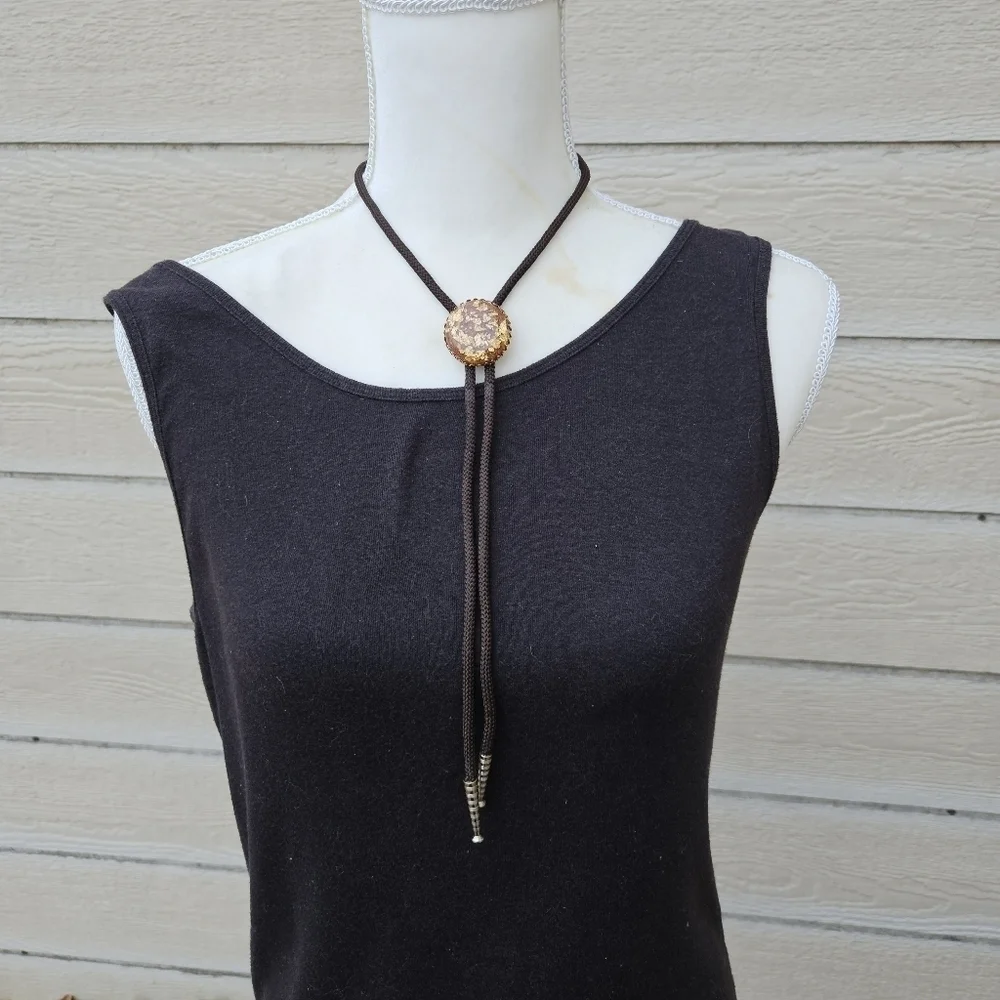 gold leaf and goldstone bolo tie on brown cord